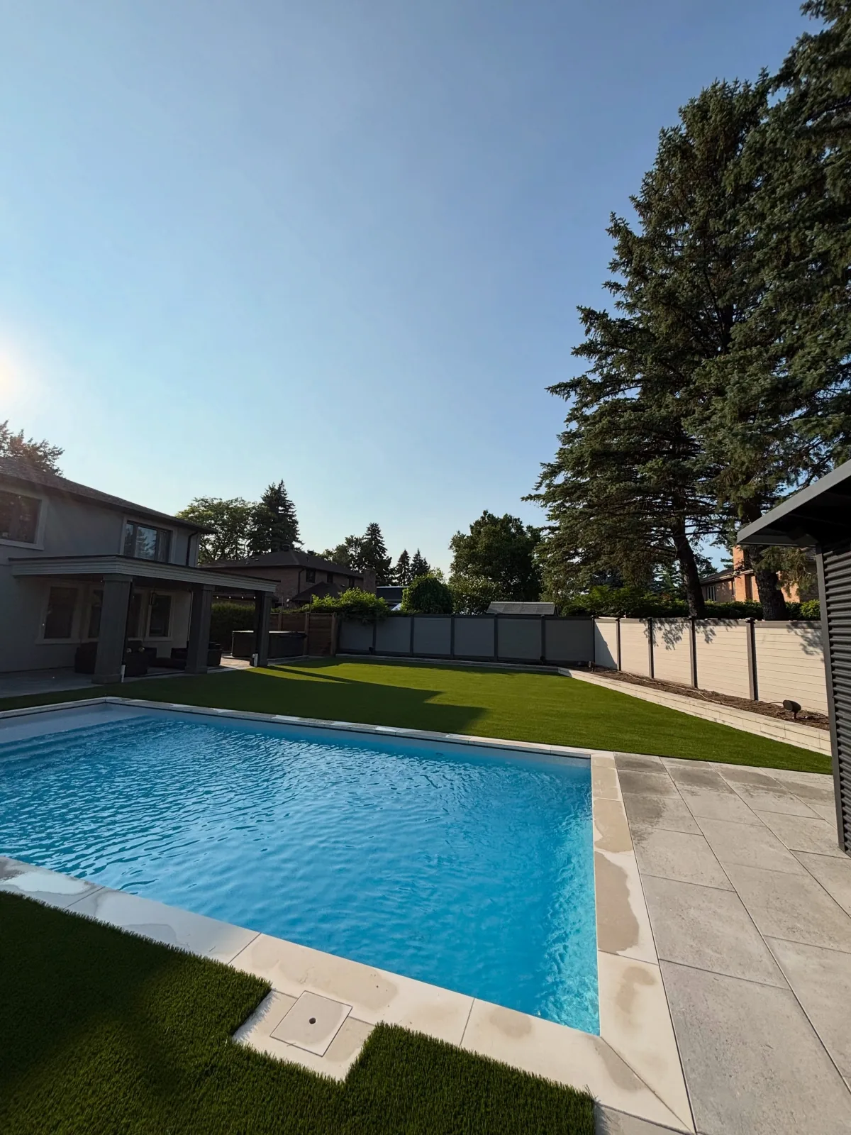 Poolside artificial grass installation in Ajax